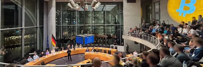 A giant Bitcoin logo projected onto the German Parliament building